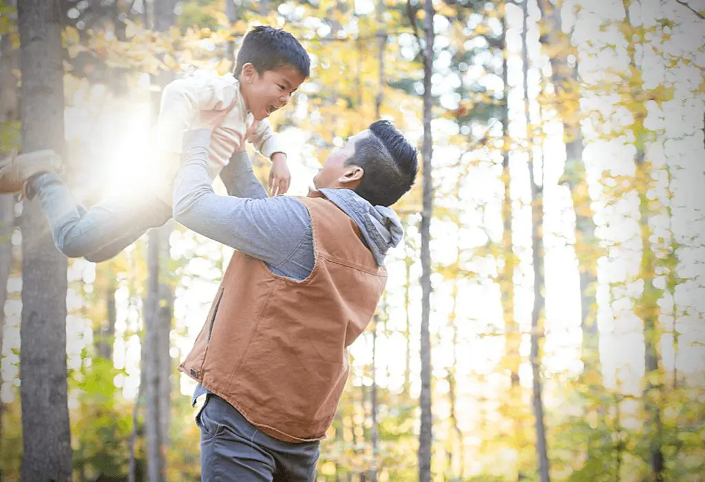 Dad in slacks playing with son