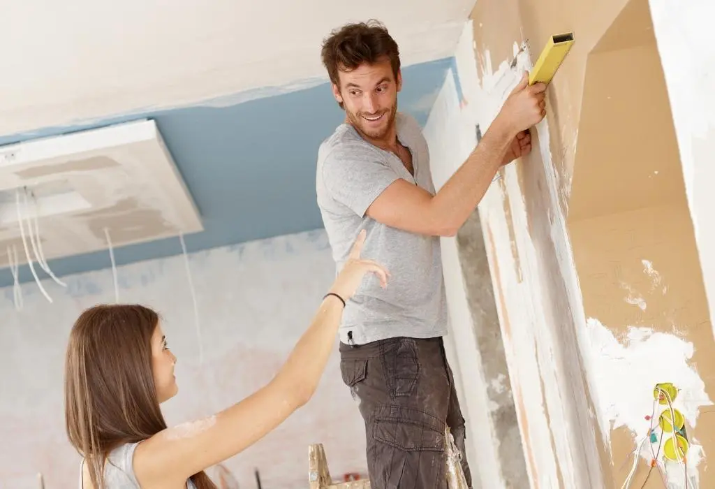 man doing DIY for woman - older men with younger women