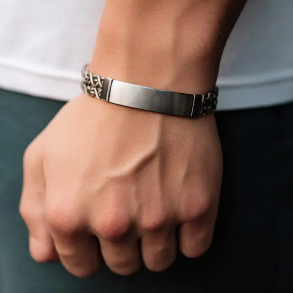 man wearing id bracelet