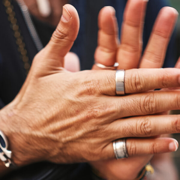 man wearing multiple rings