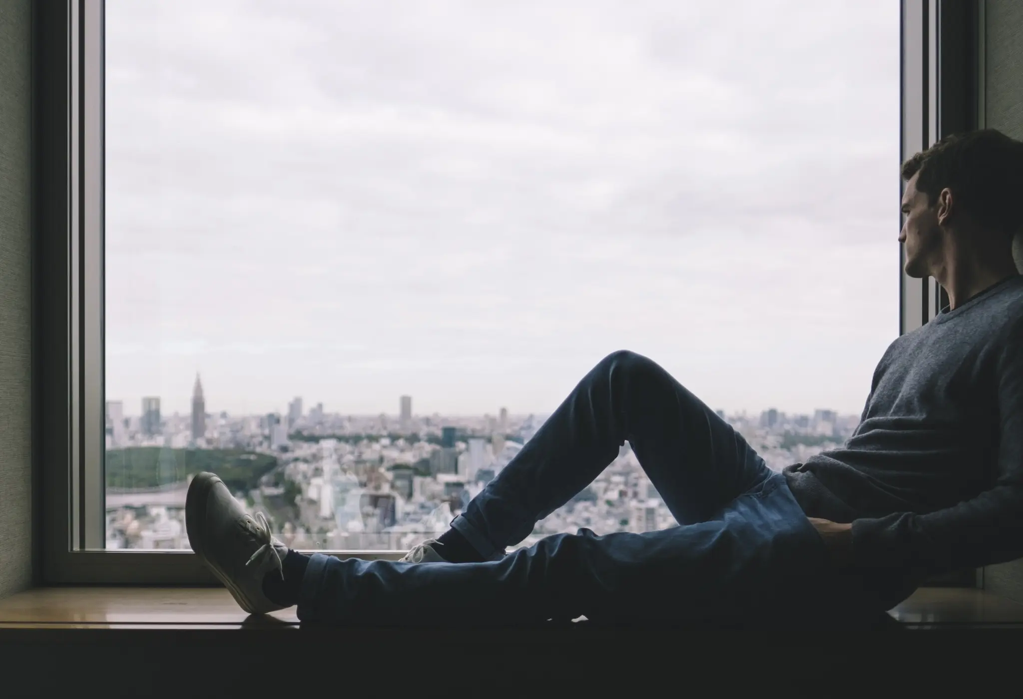 man stares out a window