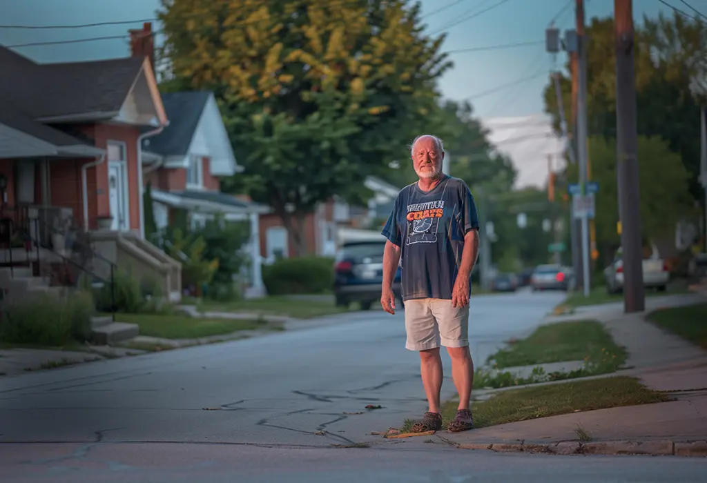 sloppy-looking man in long shorts, an old sports jersey that doesn’t fit, and crocs