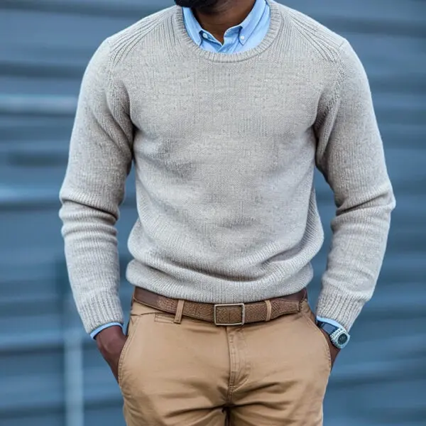 man wearing button down shirt with crew neck sweater and chinos